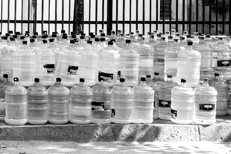 Varied drinking water sources in India - 20 liters water bottles ready for sale in South-East district, National Capital Territory of Delhi